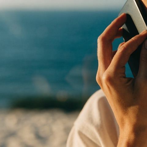 Client on a phone call by the coast